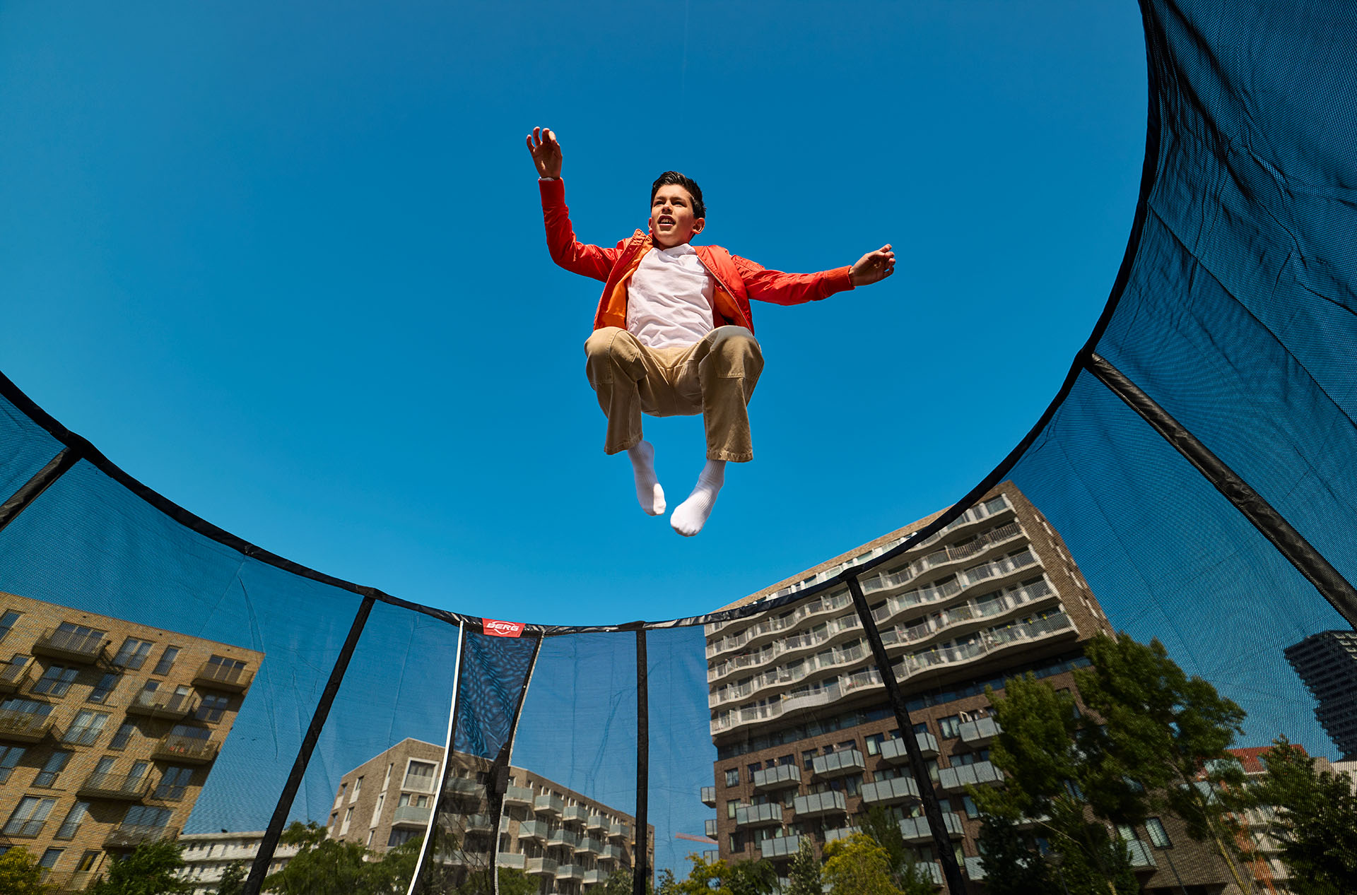 Children playing on a BERG Champion trampoline in a garden — BERG Trampolines Limerick